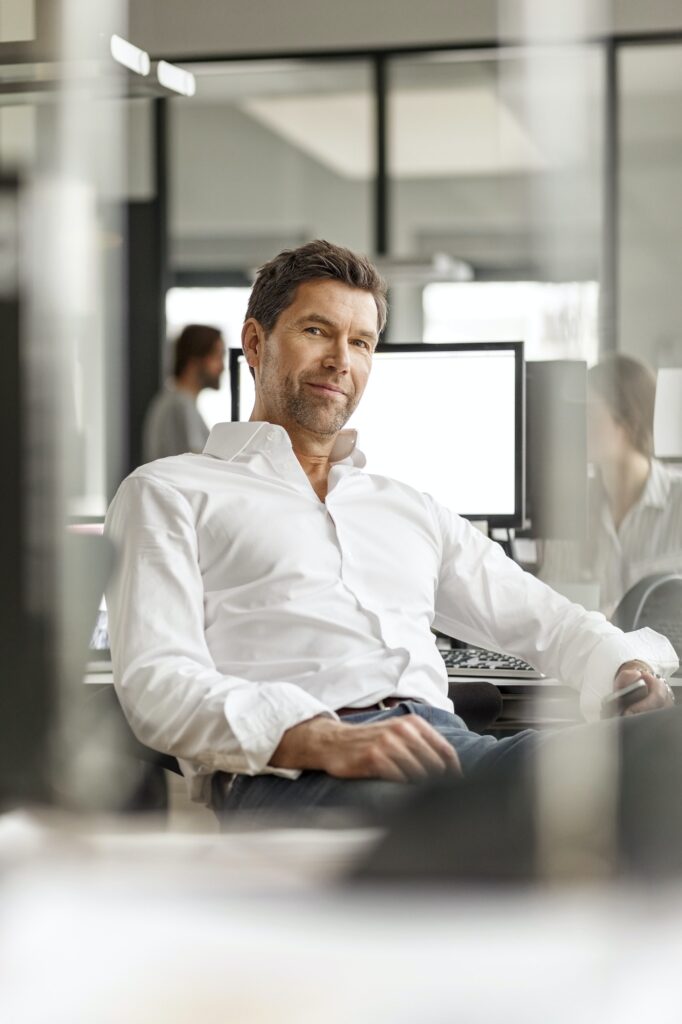 Portrait of businessman at desk in office